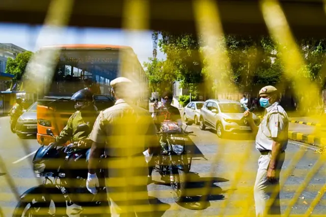 A policeman checks motorists at a roadblock