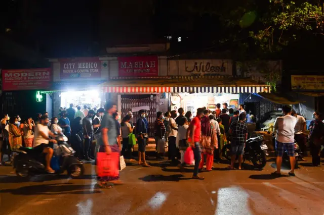 People lineup outside stores to buy groceries