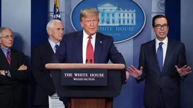 US President Donald Trump, flanked by (from R) US Secretary of the Treasury Steven Mnuchin, US Vice President Mike Pence and Director of the National Institute of Allergy and Infectious Diseases Anthony Fauci, speaks during the daily briefing on the novel coronavirus, Covid-19