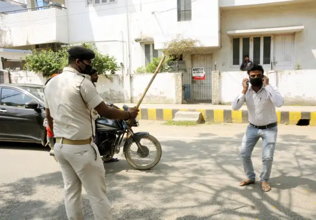 Indian policemen dealing with lockdown violators