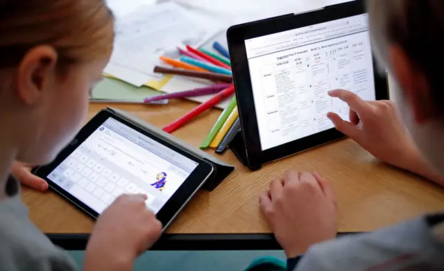 children working on tablets