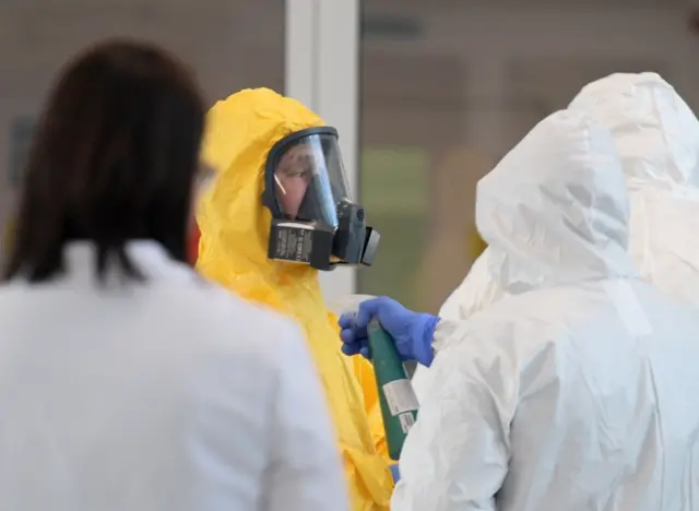 Russian President Vladimir Putin wearing protective gear visits a hospital where patients infected with the coronavirus are being treated in the settlement of Kommunarka in Moscow on 24 March 2020