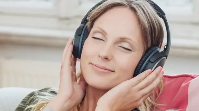 Woman listening to headphones