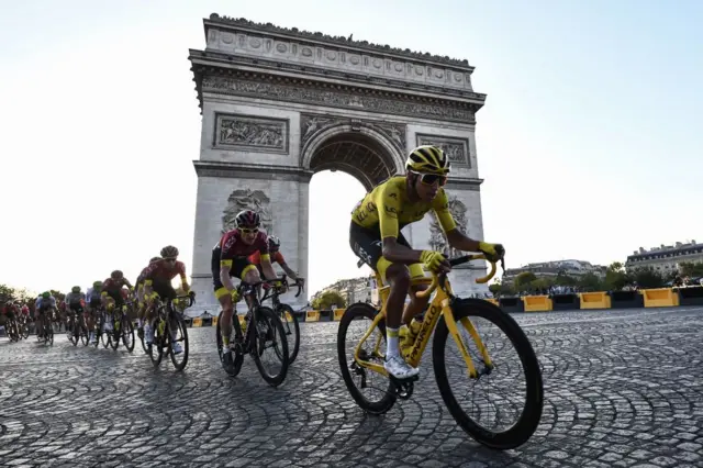 Tour de France winner Egan Bernal rides in front of the Arc de Triomphe in Paris