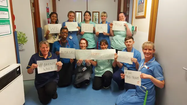 Medical staff holding signs