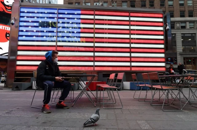 Man in front of US flag