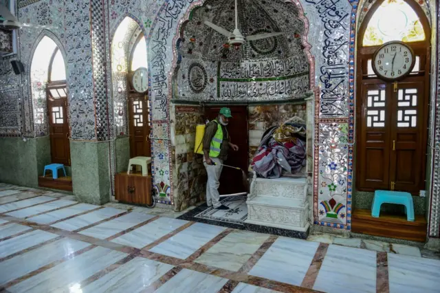 A worker disinfects a mosque, amid concerns over the spread of the Covid-19 novel coronavirus, in Karachi on March 21, 2020