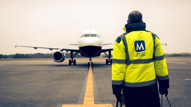 John Menzies staff member at airport