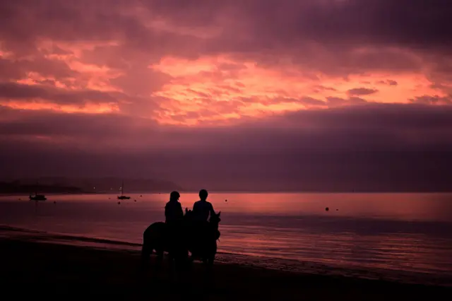 Two people on horses at Balnarring beach in Victoria this morning