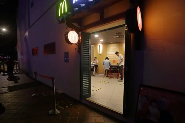 Social distance markers for queueing are seen at a McDonald's outlet