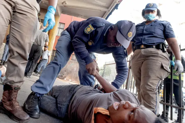 A man being arrested for having alcohol in Johannesburg, South Africa - 27 March 2020