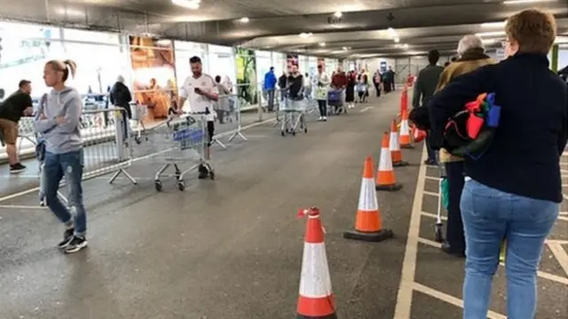 People queuing outside Tesco in Stretford, Manchester