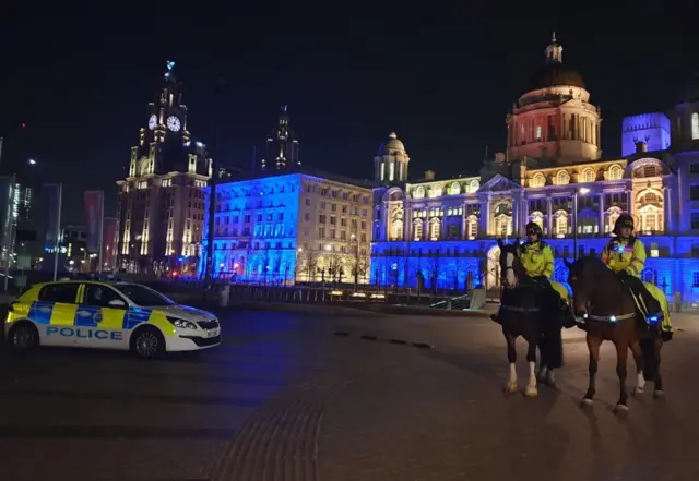 Liverpool waterfront buildings lit up blue