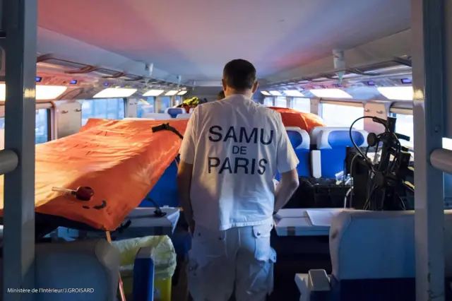 A member of the Paris Emergency Medical Aid Service (Samu) walking in a car of a medically adapted high-speed TGV train to transport Covid-19 patients (French interior ministry handout picture 26 March 2020)