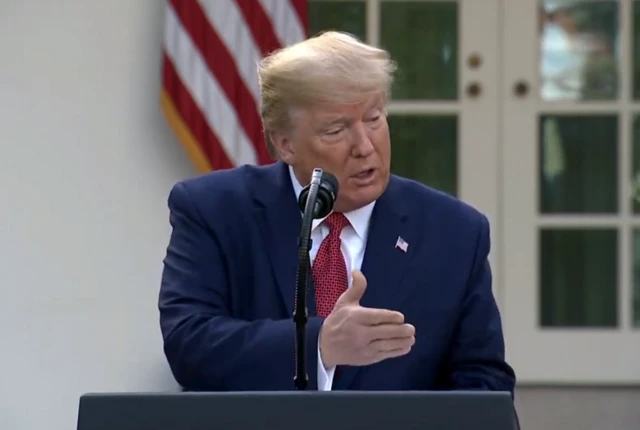 Donald Trump speaking at a press conference outside the White House