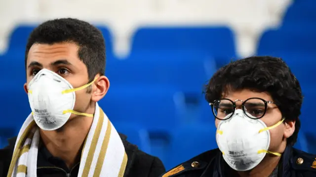 Two football fans wearing face masks at a Real Madrid game