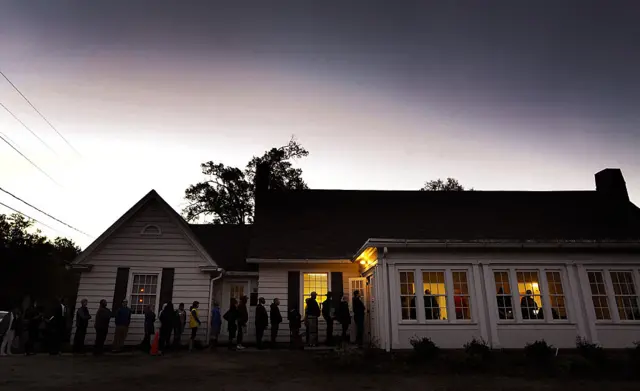 A line forms outside a voting precinct before it opens on November 8, 2016 in Durham, North Carolina