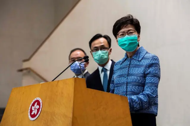 Earlier, Hong Kong leader Carrie Lam announced four flights to bring back 533 residents from Wuhan. She wore a mask during her news conference.