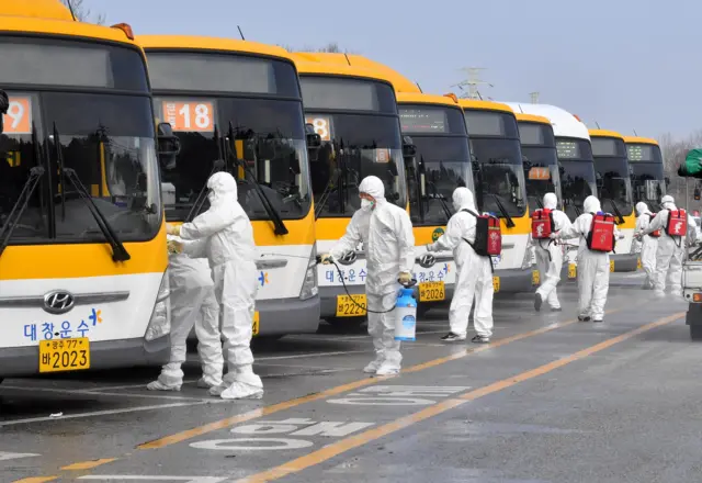This picture from a bus garage in Gwangju shows workers disinfecting their vehicles.