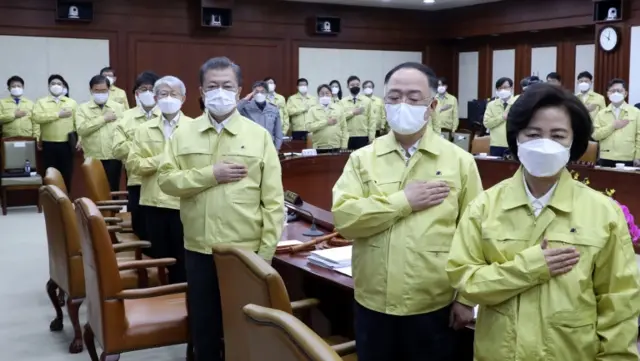 South Korean President Moon Jae-in (third from the right) and his ministers wear face masks to attend a cabinet meeting in Seoul on Tuesday.