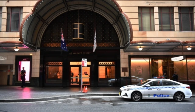 Police officer and police car outside the Swissotel in Sydney during travel quarantine