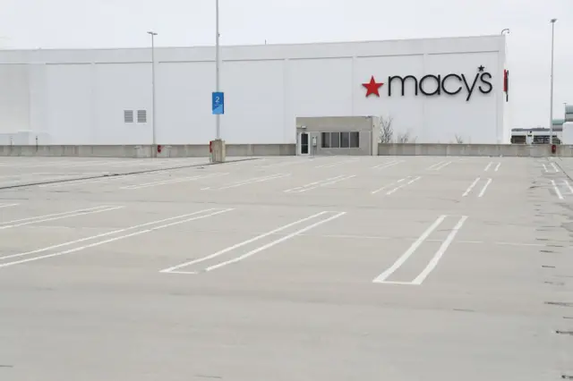 Macy's department store is shown with an empty parking lot amid the coronavirus pandemic at the Roosevelt Field Mall on 20 March, 2020 in East Garden City, New York