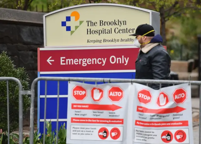 A New Yorker waits outside a Brooklyn hospital to be tested