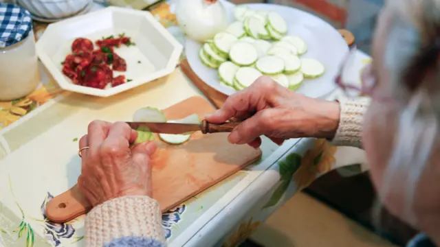 An older person cooking