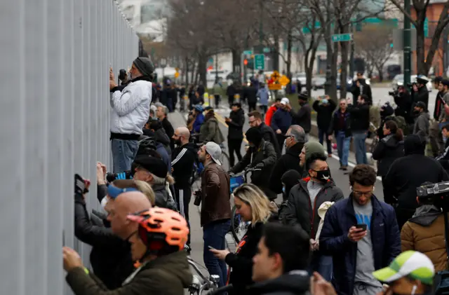 Crowds gather to watch USNS Comfort docking at Pier 90 in New York City