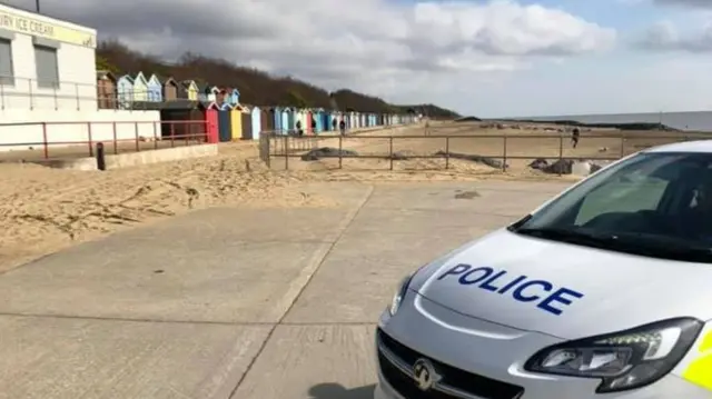 Police car by beach