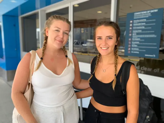 Katie Burrows (left) and Lily Hawkins outside Sydney Airport