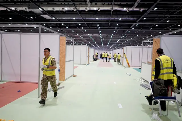 Military personnel helping to build the NHS Nightingale Hospital