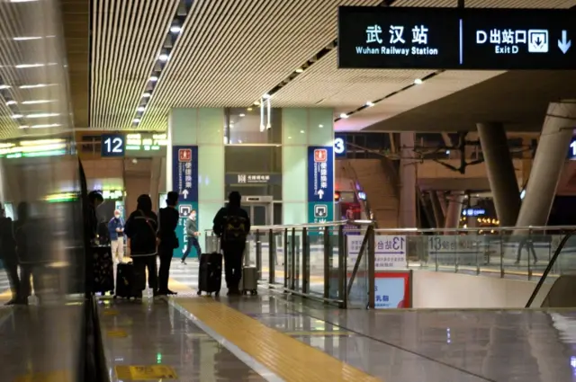 Passengers get off a train at a railway station in Wuhan. Photo: 4 March 2020