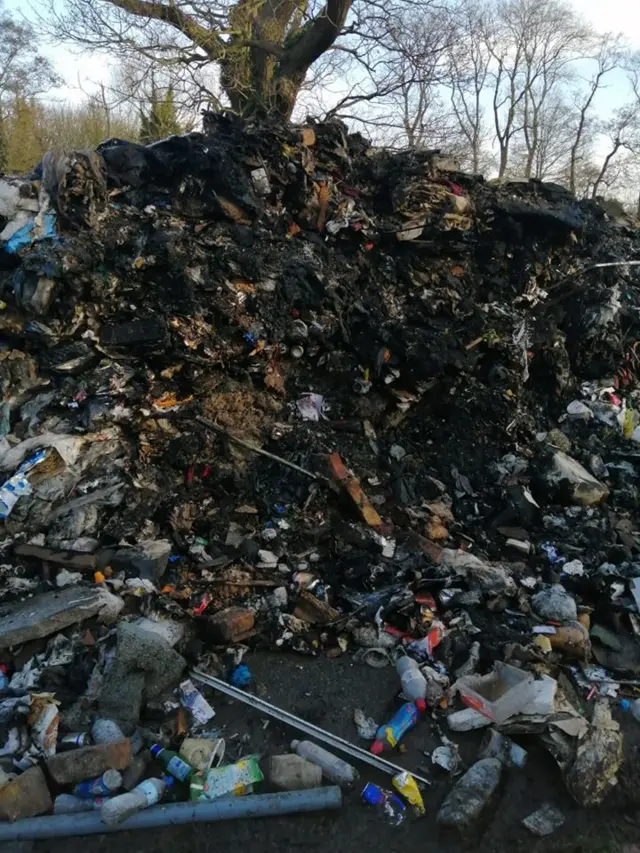 Pile of burned rubbish in Watery Gate Lane