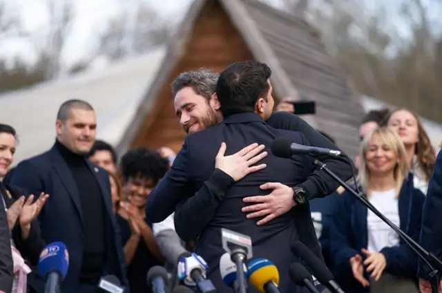 Ukrainian President Volodymyr Zelensky hugs one of the evacuees in Novi Sanzhary, central Ukraine. Photo: 5 March 2020