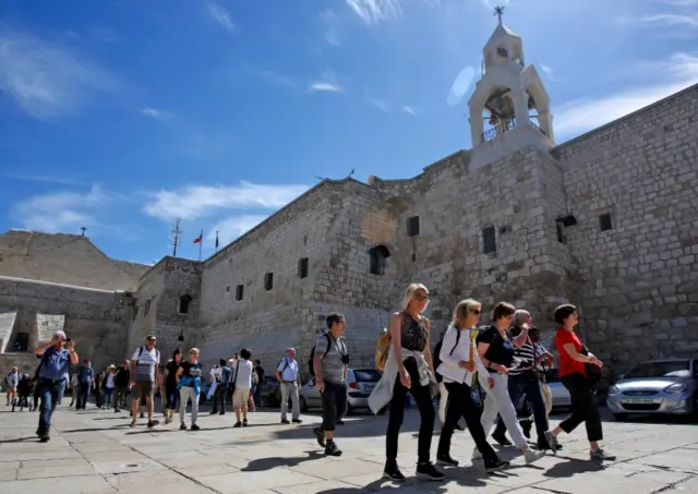 Foreign tourists visit the Church of the Nativity, revered as the birthplace of Jesus Christ, in the West Bank city of Bethlehem on March 05, 2020.