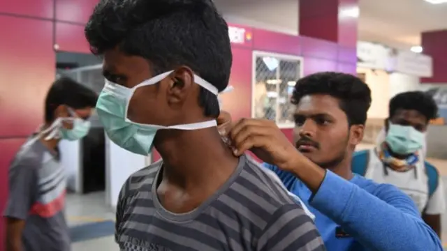 Indian men adjusting a face mask