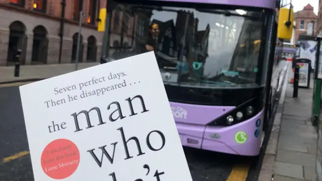 A book with a bus in the background