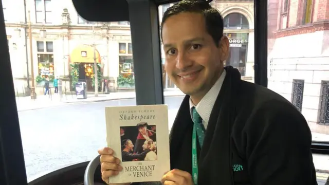 Bus driver holding a book