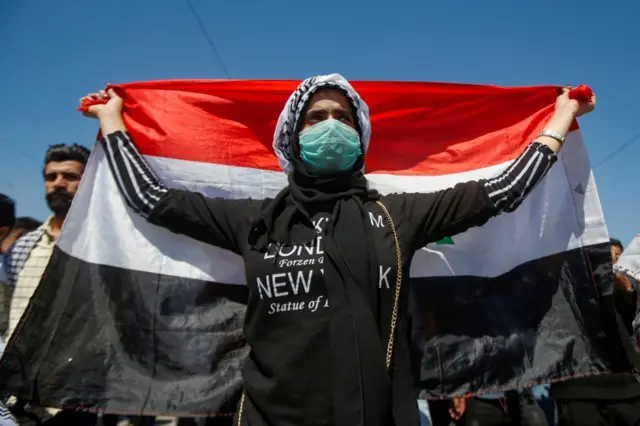 A student wears a protective face mask during ongoing anti-government protests in Basra