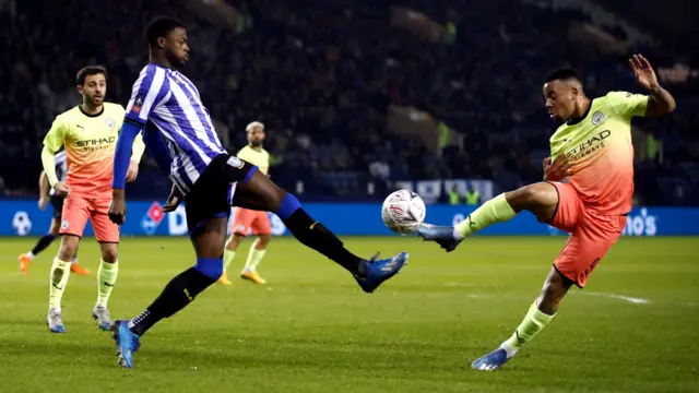 A Sheffield Wednesday player battles for the ball