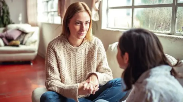 Woman talking to child