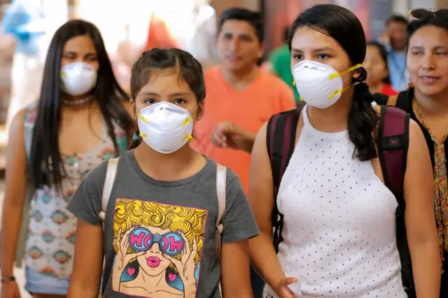 People wear masks at Lima's airport, Peru. Photo: 6 March 2020