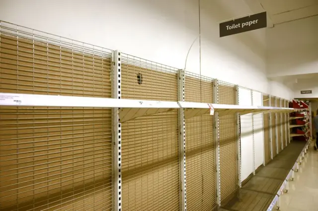 Shelves are empty of toilet rolls in a supermarket in Sydney on March 4, 2020