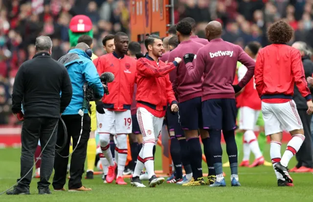 Arsenal and West Ham players avoid shaking hands