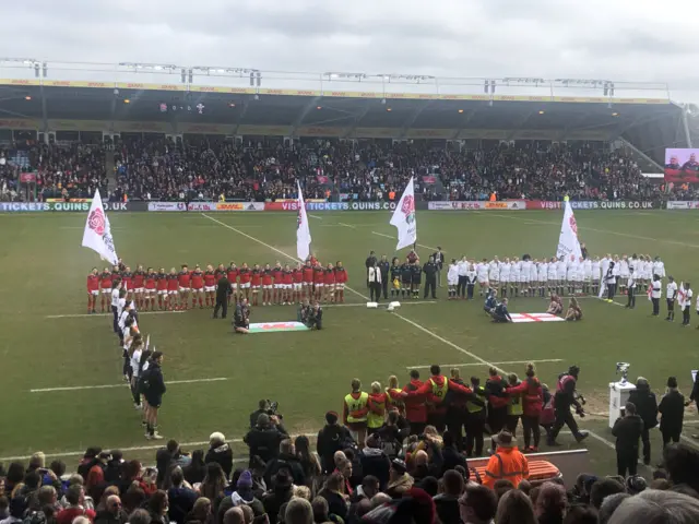 Teams line up for the anthems