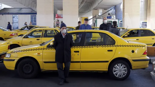 A taxi driver waits for passengers in Tehran