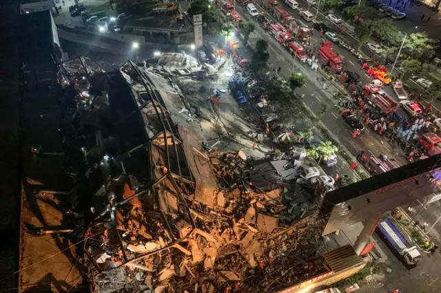 Rescuers search for survivors in the rubble of a collapsed hotel in Quanzhou