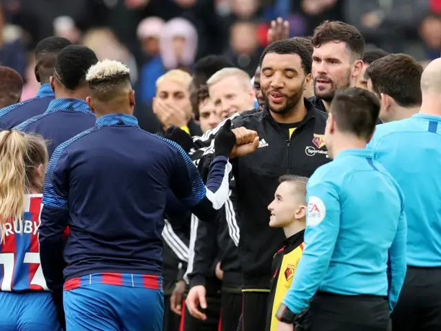 Watford's Troy Deeney and Crystal Palace's Patrick van Aanholt bump fists