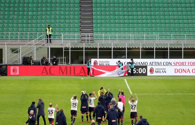 Genoa players celebrate after the Italian Serie A soccer match against AC Milan